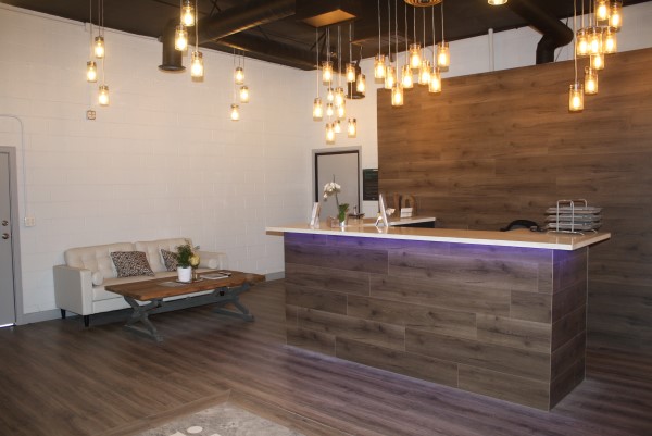 Contact Auto Body Shop - Modern and comfortable customer waiting area at IQ Collision Center, featuring a clean lobby and reception desk for a professional experience.