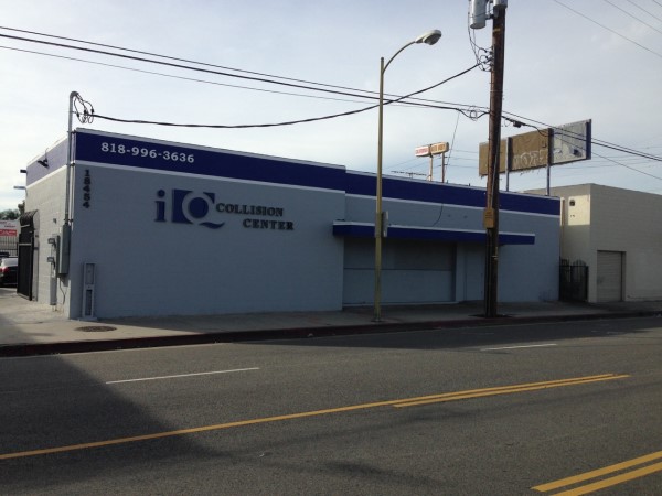 The exterior storefront of IQ Collision Center, an auto body repair shop specializing in professional collision restoration services.