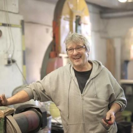 Smiling experienced auto body technician at IQ Collision Center, part of our professional vehicle repair staff.